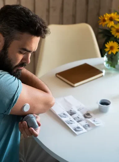 Person checking health readings to understand diabetes and fatigue symptoms