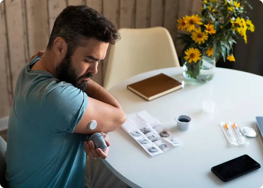 Person checking health readings to understand diabetes and fatigue symptoms