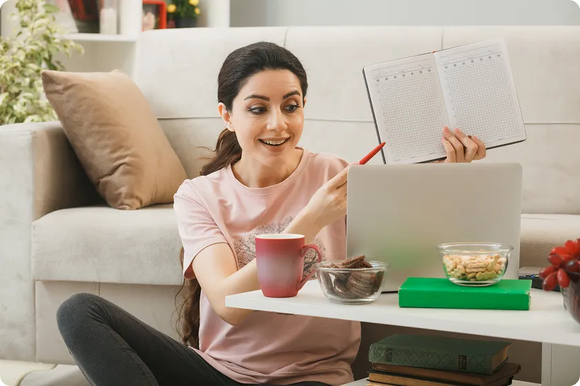 Woman holding a calendar while reviewing workout plan to lose weight.
