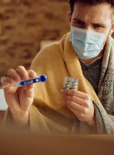 Woman holds medicine while learning how to prevent C diff