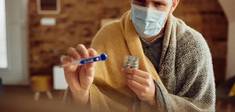 Woman holds medicine while learning how to prevent C diff