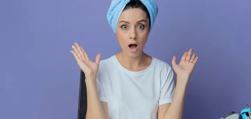 Woman applying moisturizer as part of a daily skin care routine