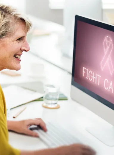 Older woman uses online resources to advocate for yourself during cancer care.