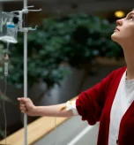 Seated patient receiving NAD+ IV drips under NAD+ infusion safety monitoring