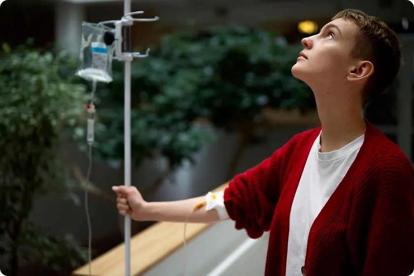 Seated patient receiving NAD+ IV drips under NAD+ infusion safety monitoring