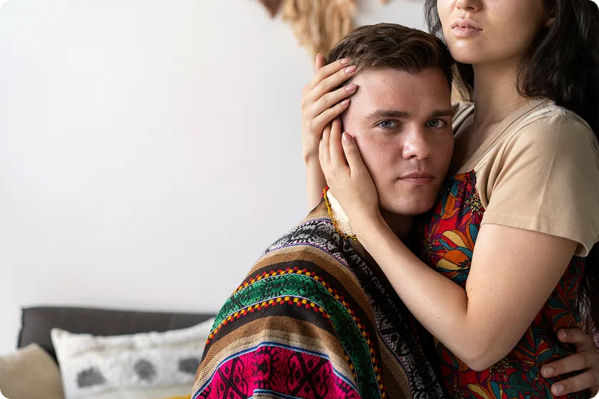 Supportive partner comforting loved one, encouraging LGBTQ+ affirming therapy and healing.