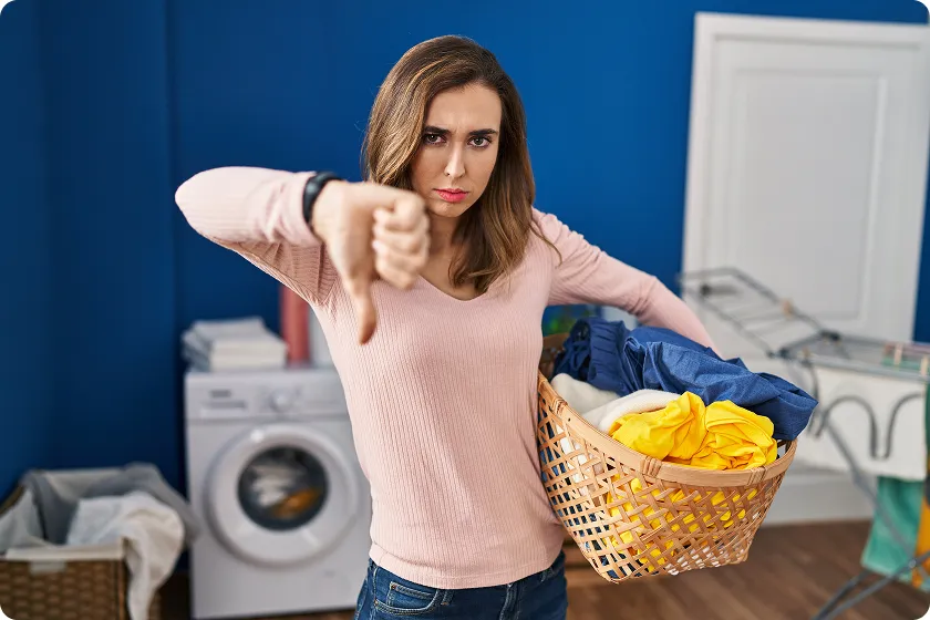 Clinician examines facial rash linked to contact dermatitis from detergent.