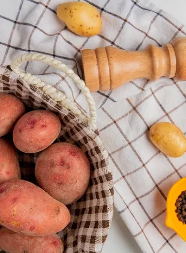 2_4_11zon Fresh raw potatoes arranged in a basket for preparing sweet potato gerd recipes.