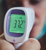 Infrared thermometer reading displays temperature while maintaining normal room temperature conditions home.
