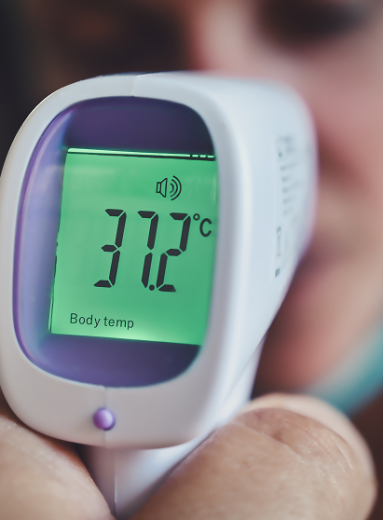 Infrared thermometer reading displays temperature while maintaining normal room temperature conditions home.