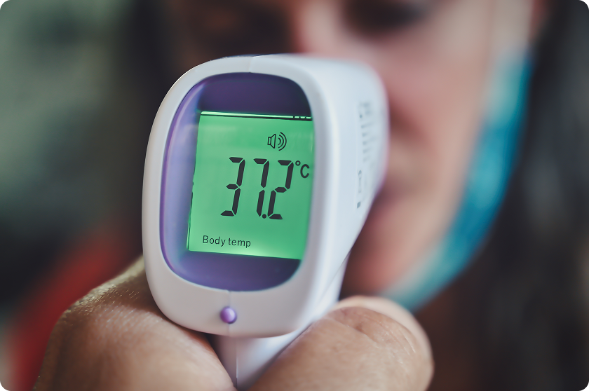 Infrared thermometer reading displays temperature while maintaining normal room temperature conditions home.