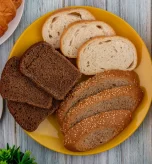 Yellow plate filled with various baked goods illustrating typical carbs in bread options.