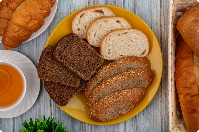 Yellow plate filled with various baked goods illustrating typical carbs in bread options.